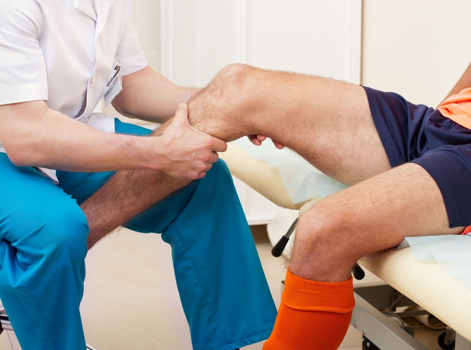 Examination of a sore joint by a doctor
